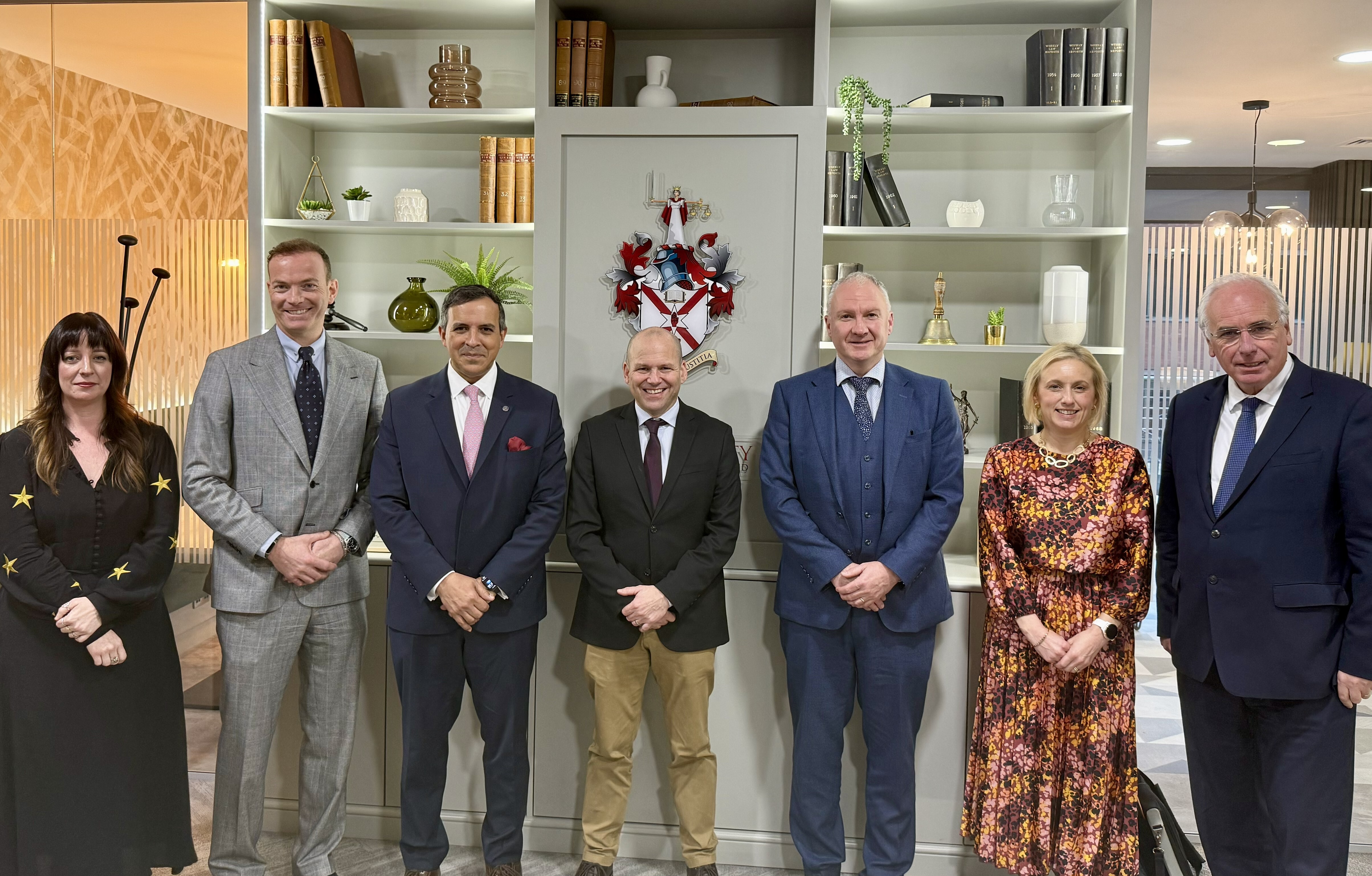 Law Society and Panel members standing in front of the Society crest.