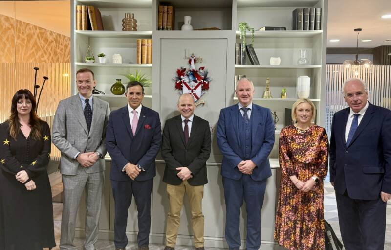 Law Society and Panel members standing in front of the Society crest.