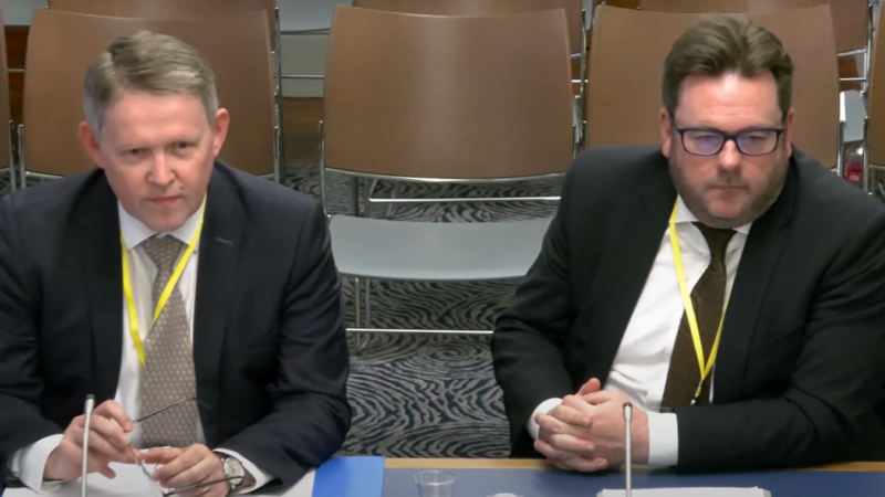 Joe McVeigh and Eoghan McKenna sitting at a desk presenting to the Justice Committee