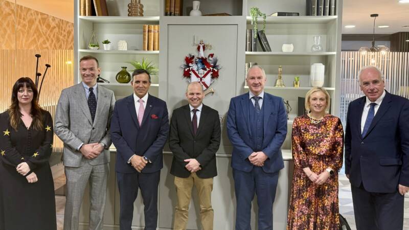 Law Society and Panel members standing in front of the Society crest.