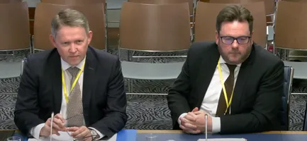 Joe McVeigh and Eoghan McKenna sitting at a desk presenting to the Justice Committee
